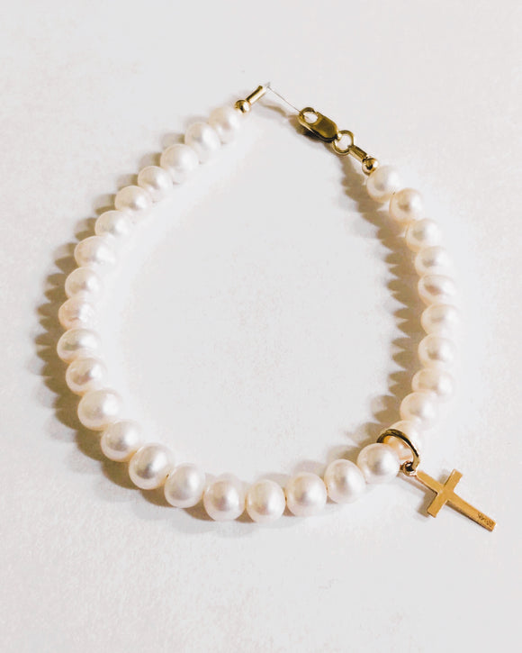 14 KT Genuine freshwater pearls potato shape with latin polished cross charm. Gold lobsters clasp and gold chain tag. Size 6 inch or size 6.5 inch. 