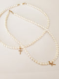 14 Kt Diamond cross on freshwater pearl necklace yellow gold 15 inches